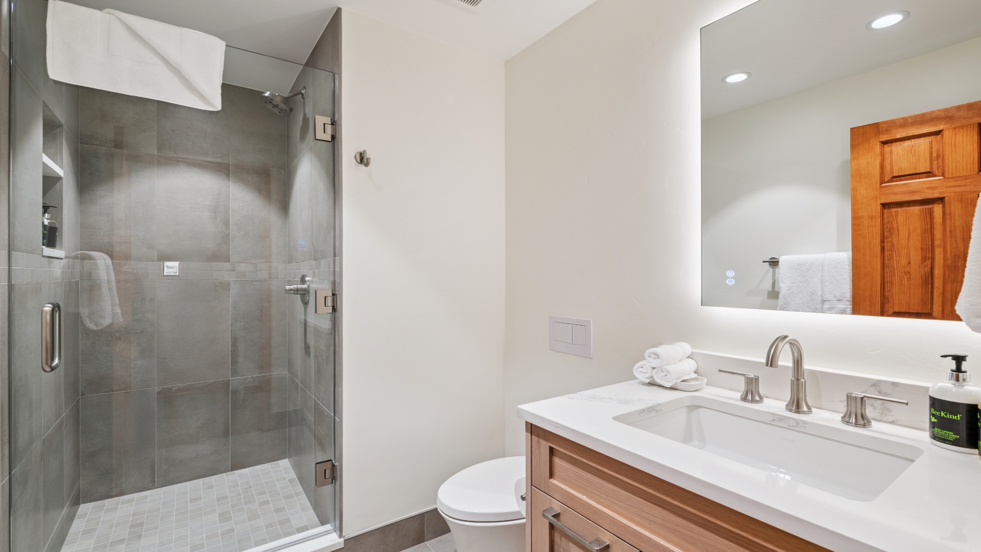 Step into your private en-suite bathroom with a spacious walk-in shower, elegant vanity, and fresh towels waiting—your perfect retreat after a day of adventure.
