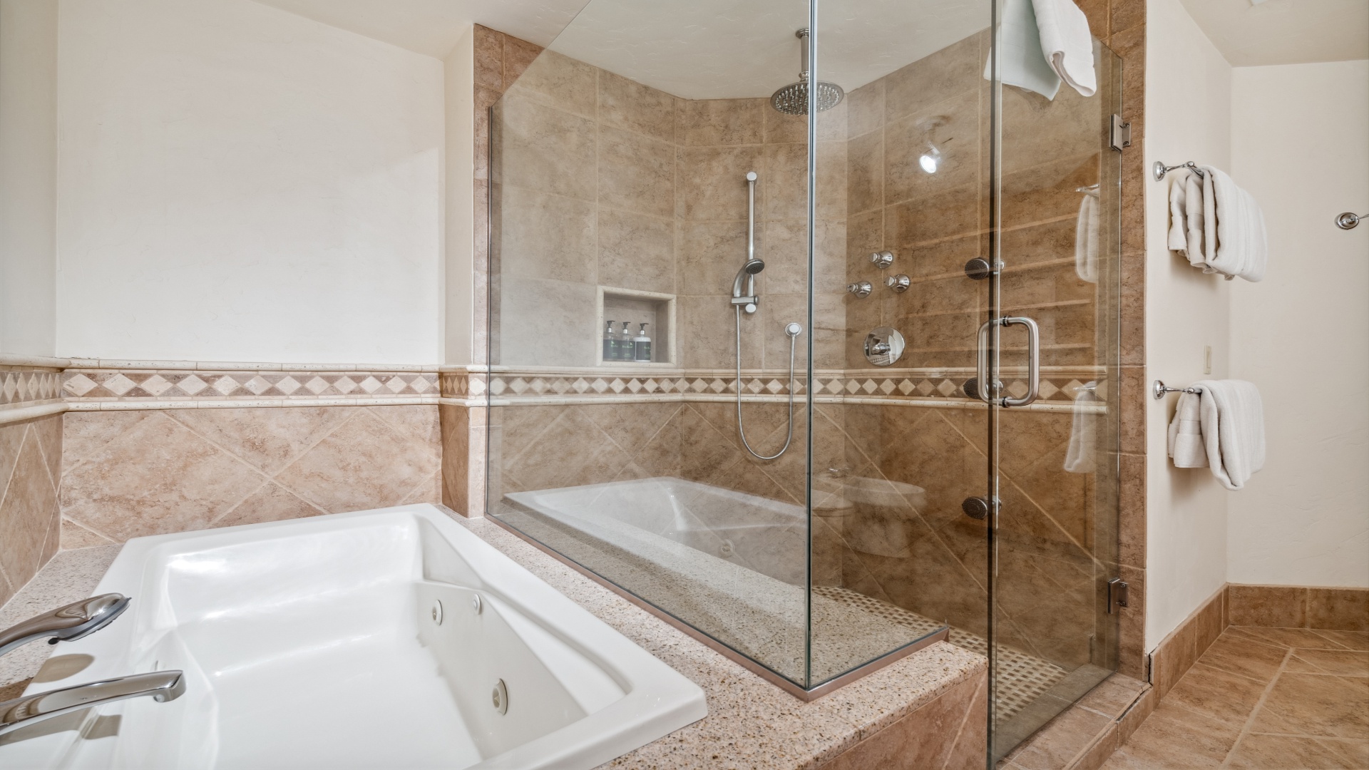 Refresh in a spa-inspired bathroom with a spacious walk-in shower and soaking tub. You'll appreciate the elegant tile details and fresh towels ready for your stay.