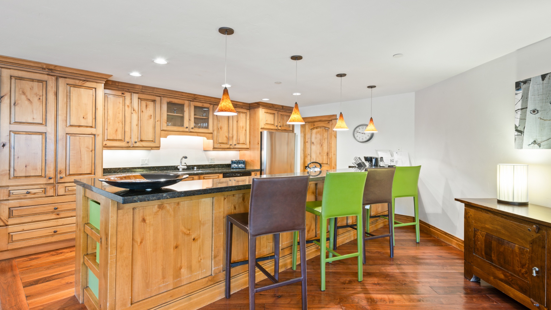 Gather around the spacious island in your fully-equipped kitchen, where warm wood tones and modern conveniences blend beautifully. The sleek pendant lights and ample counter space set the stage for your culinary adventures.
