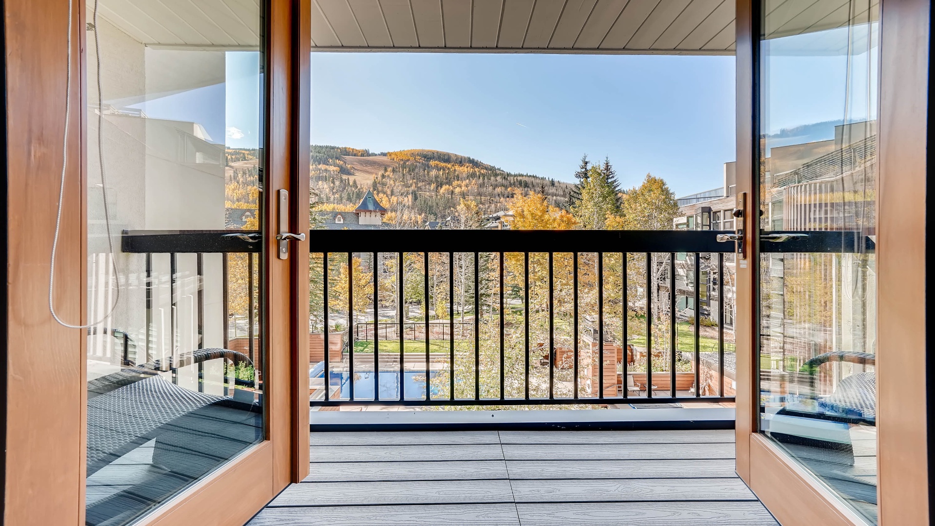 Step through your private balcony doors to breathtaking mountain views framed by golden autumn foliage—a serene escape where crisp air and natural beauty await just beyond your room.