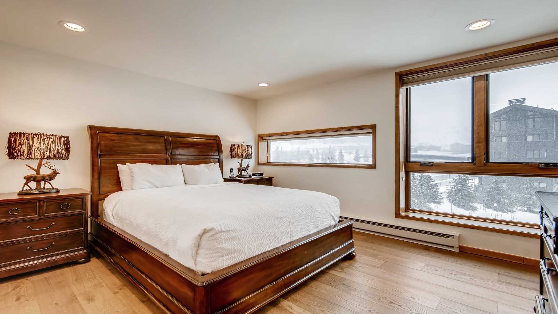 Sink into crisp white linens and wake to snowy mountain views framed by warm wood-trimmed windows. A peaceful mountain retreat awaits your arrival.