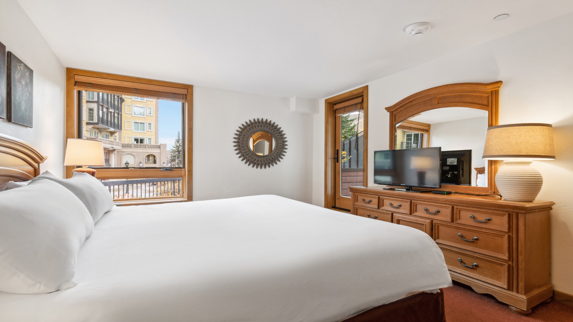 Unwind in your tranquil bedroom retreat, where crisp linens, warm wood accents, and sunlit views welcome you to relax after a day of mountain adventures.