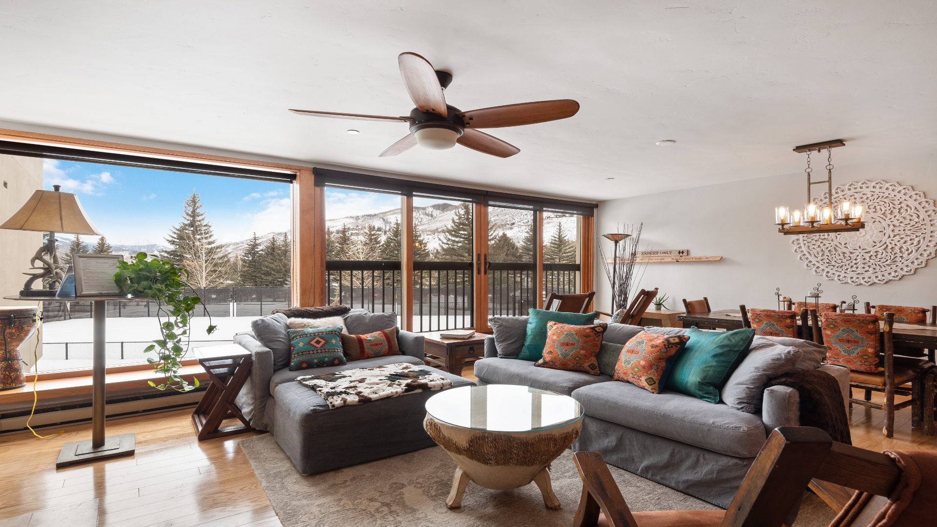 Settle into your cozy mountain retreat where panoramic views frame snowy peaks through expansive windows.