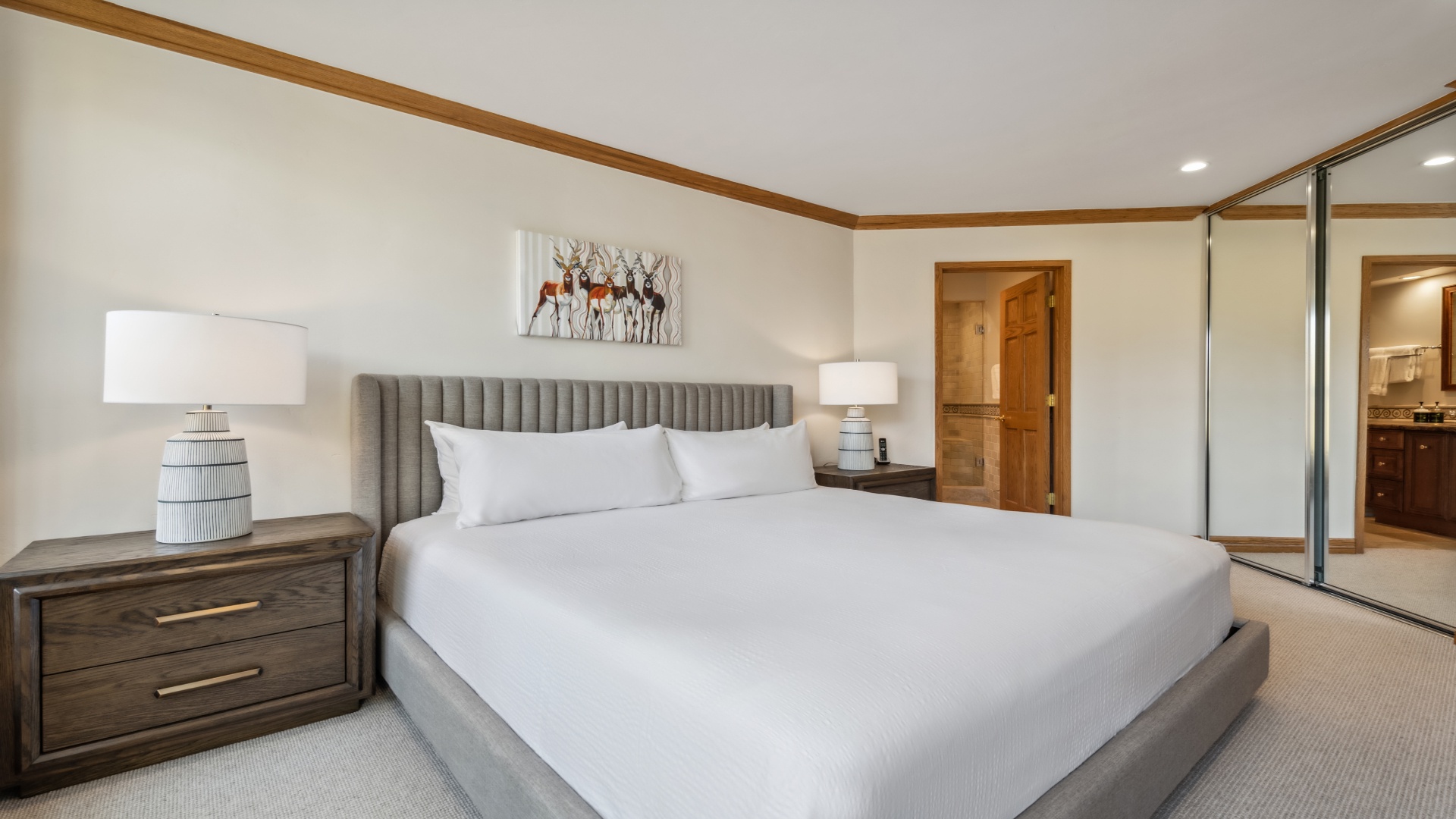 Sink into crisp linens and enjoy your private retreat with elegant finishes and warm wood accents that make relaxation effortless.