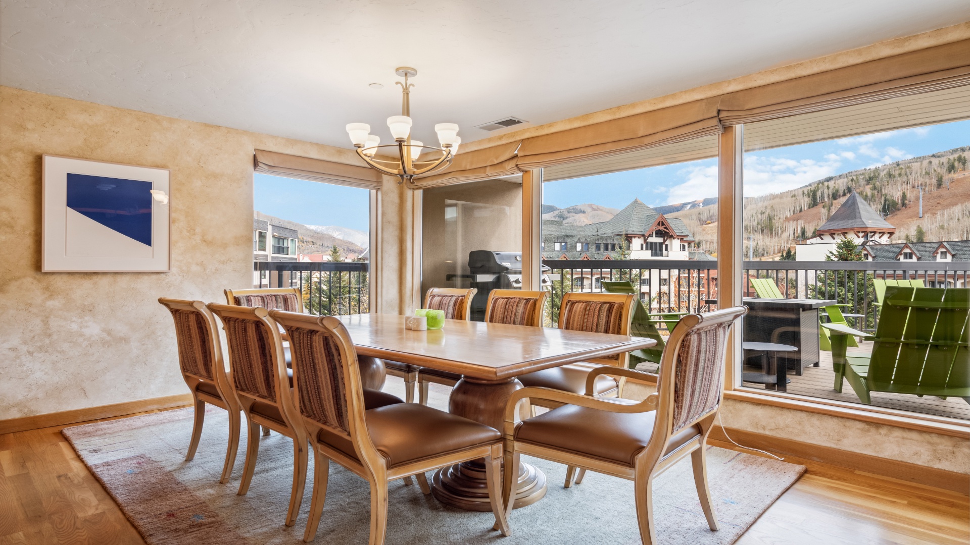Gather around this elegant dining table where mountain views frame every meal. Large windows invite natural light and stunning scenery, making every dining experience feel special and connected to the beauty outside.