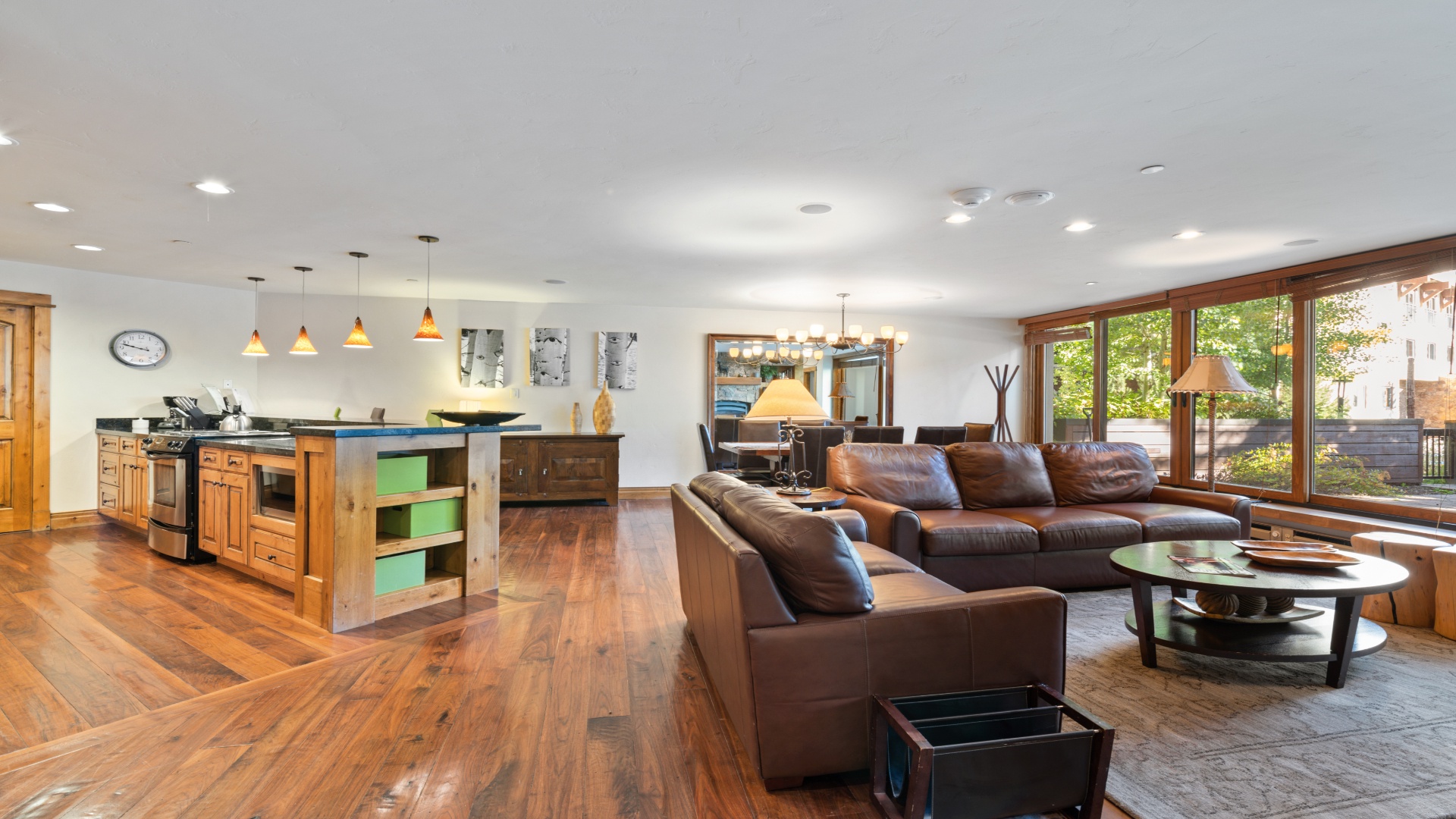Unwind in your spacious open-concept living area, where rich wood floors and natural light create a warm, welcoming retreat perfect for gathering with loved ones.
