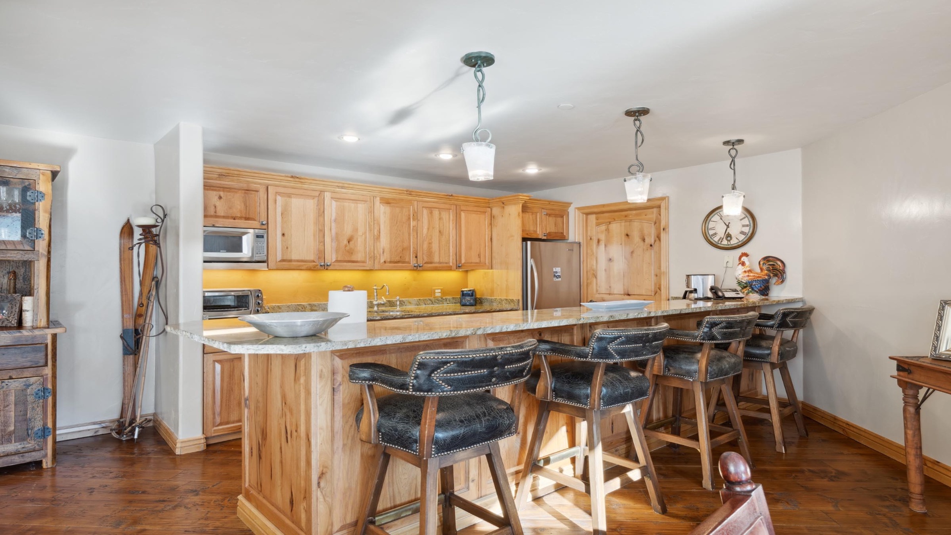 Gather around your spacious kitchen island with bar seating for memorable meals together. Warm wood cabinetry, granite counters, and stainless appliances make cooking a pleasure in this mountain-inspired space.