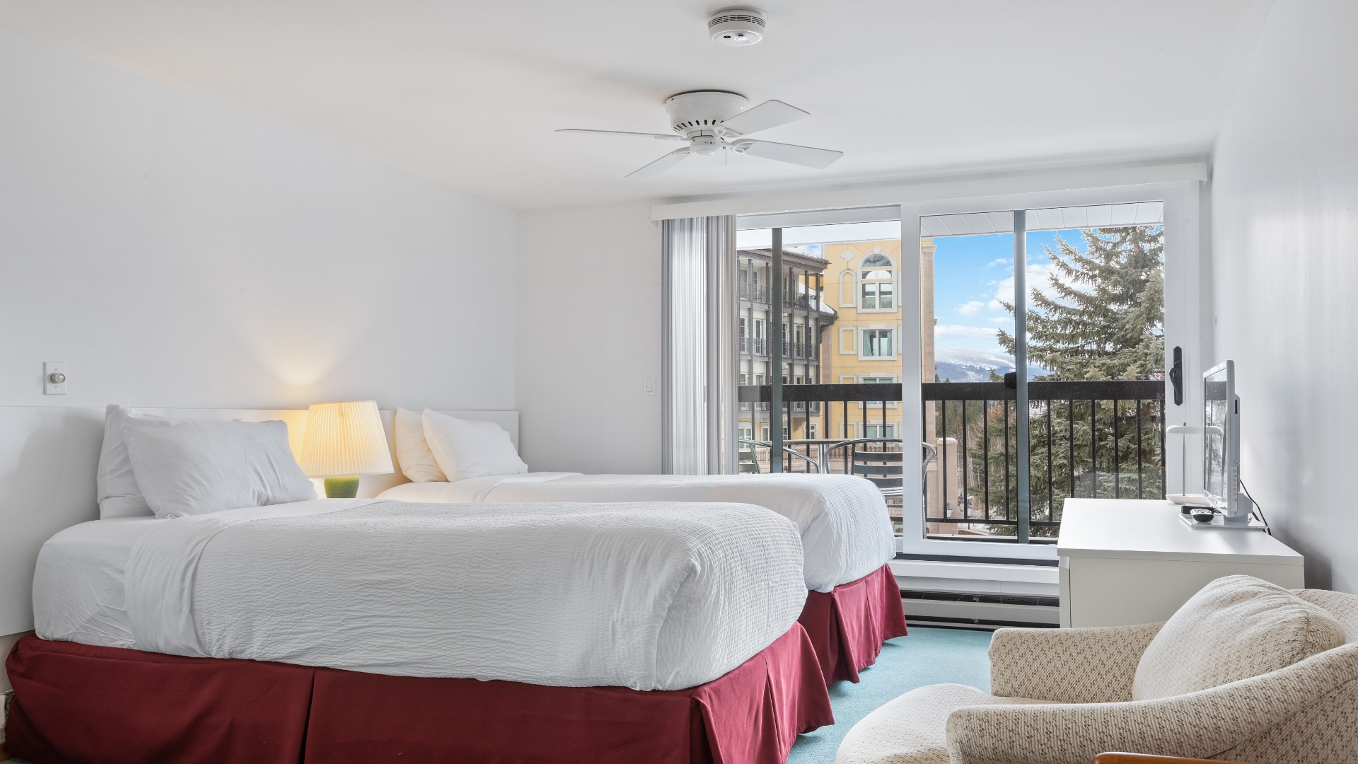 Settle into this bright, airy room where crisp linens and mountain views create your perfect retreat. Unwind in your cozy seating area or step onto your private balcony.