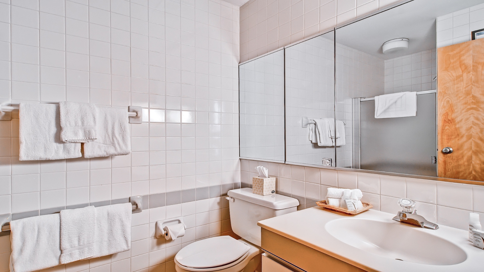 Freshen up in your private bathroom with crisp white subway tiles, plush towels, and a spacious vanity—everything you need for a comfortable stay.