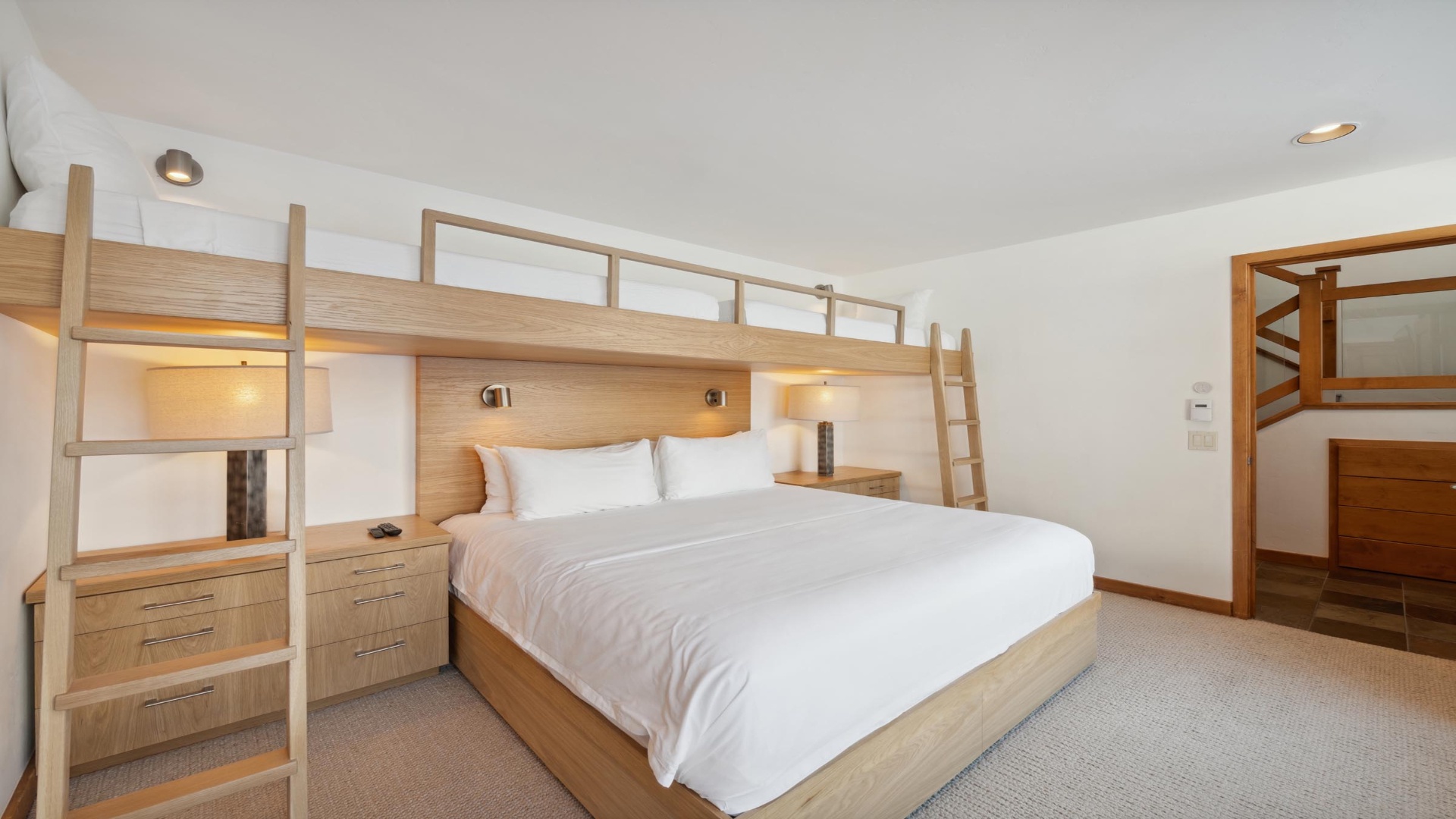Drift off in crisp linens on your king bed, while the lofted bunk creates extra sleeping space above. Warm wood tones and soft lighting surround you, making this your cozy retreat after a day of adventure.