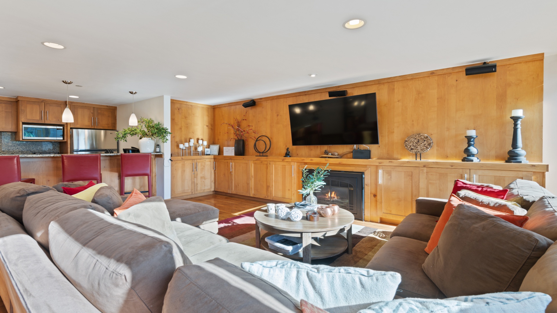 Sink into plush sofas beside a glowing fireplace and enjoy your favorite shows on the large screen in this open, beautifully-appointed living space.
