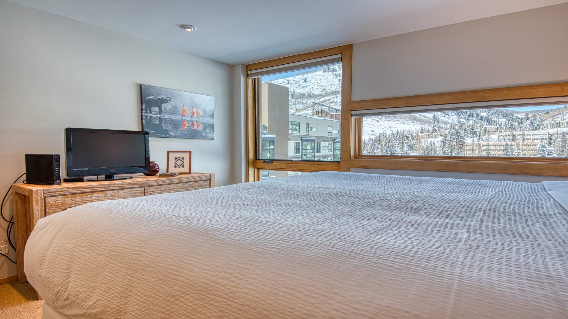 Wake up to breathtaking snowy mountain views framing your cozy bedroom, where crisp alpine air and serene winter beauty create the perfect escape.