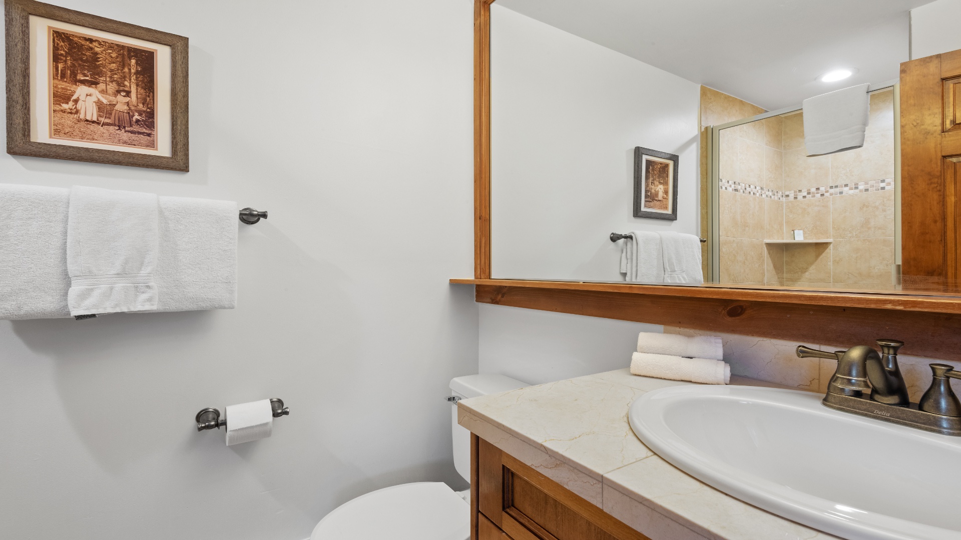 Your private bathroom offers fresh towels, a vanity with ample space, and a warm shower awaiting you after a day of adventure.
