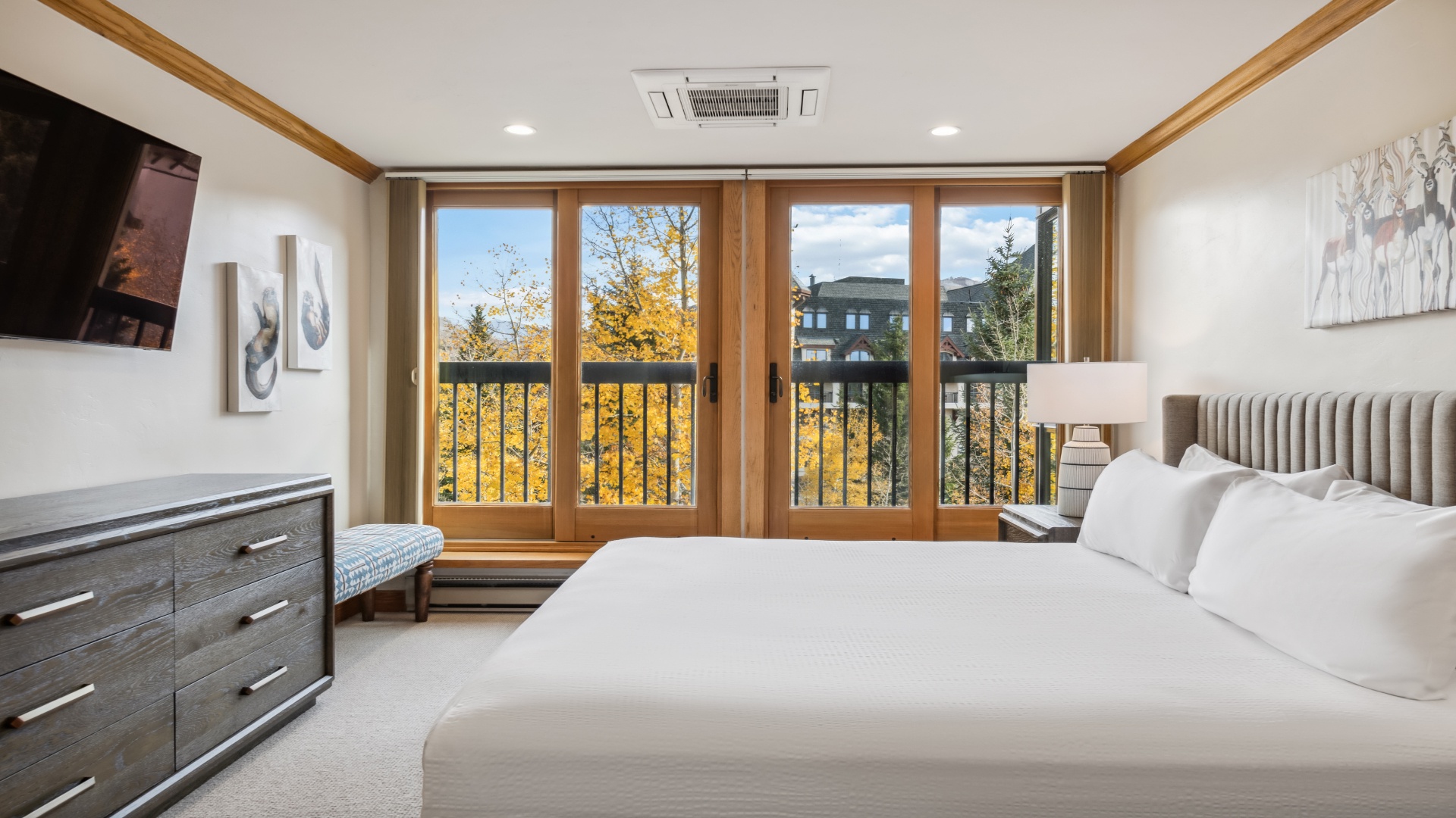Wake up to golden autumn views framed by warm wood. Your private balcony overlooks trees ablaze with fall color—perfect for morning coffee or evening relaxation in this serene retreat.