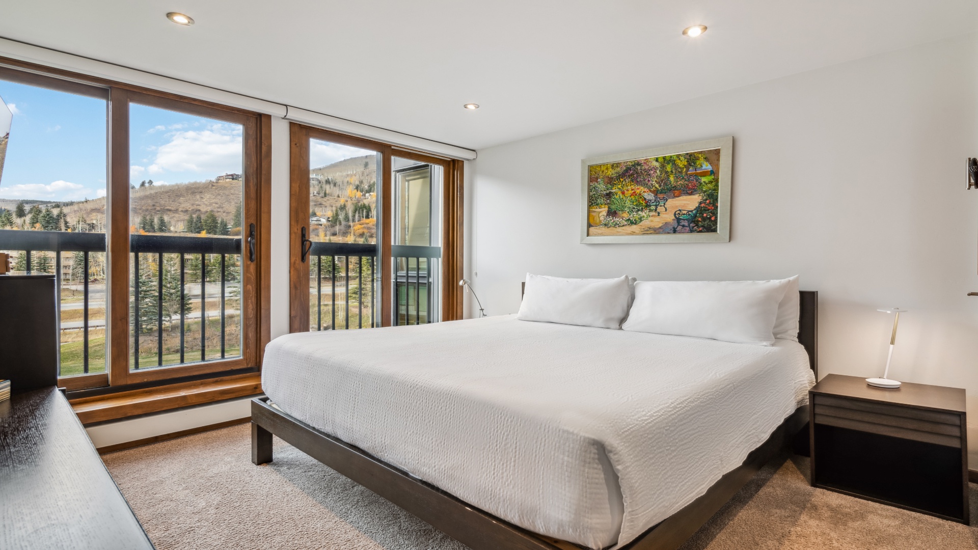 Wake up to stunning mountain views from your plush king bed, where crisp linens and peaceful hillside scenery promise restful mornings in your serene retreat.