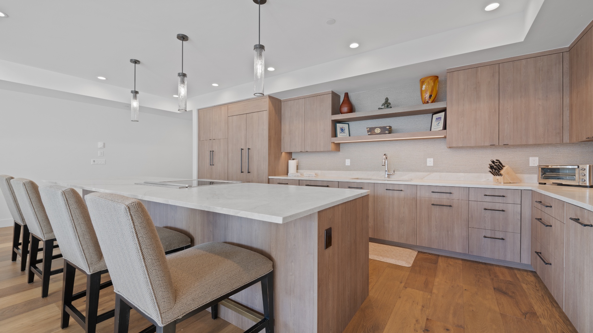 Gather around this sleek kitchen island, perfect for your morning coffee or prepping meals together. Warm wood tones and modern finishes create a space where functionality meets style, making you feel right at home.