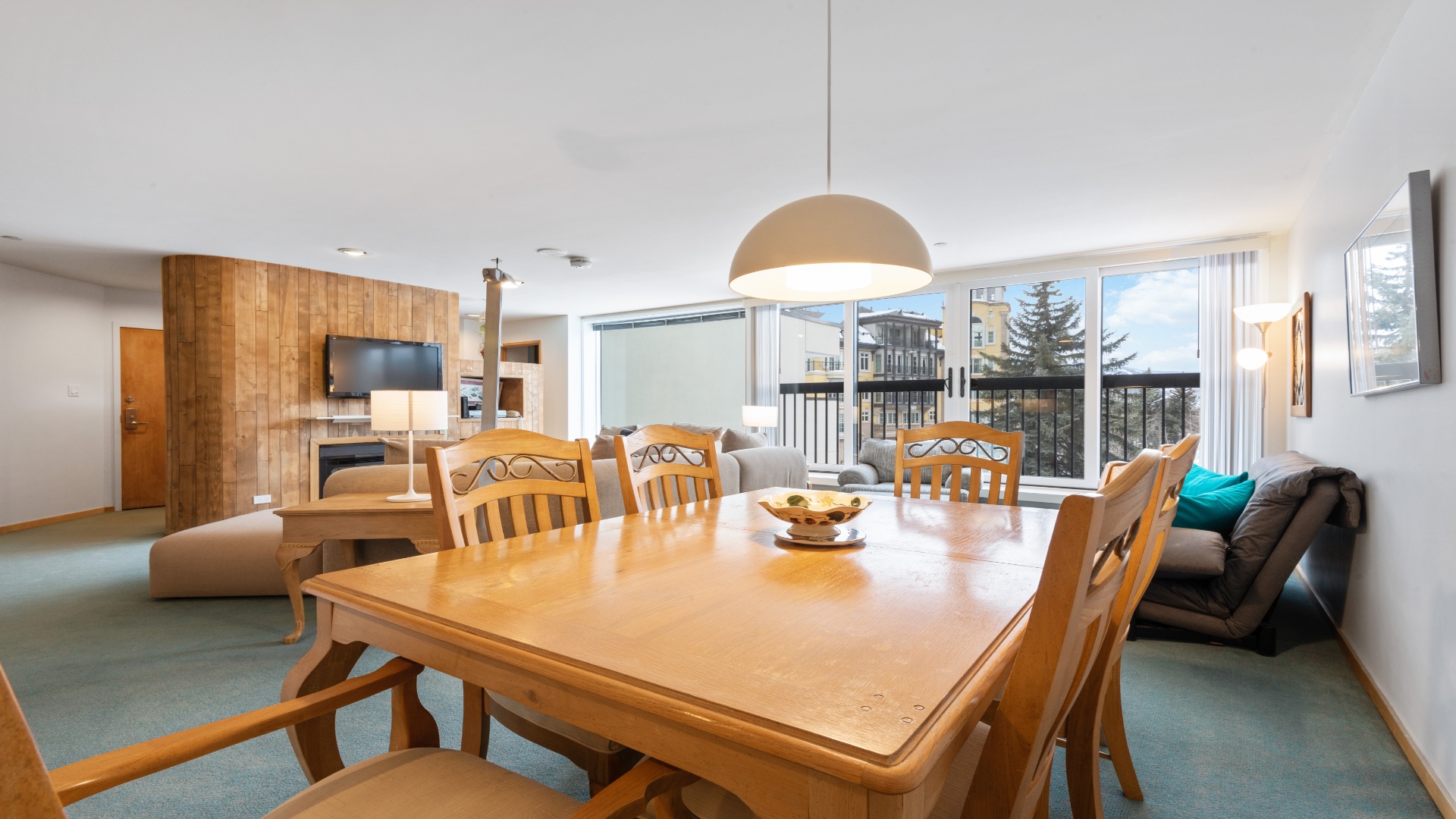 Gather around the inviting dining table for memorable meals, then unwind in the cozy living area where mountain views and modern comforts blend seamlessly.