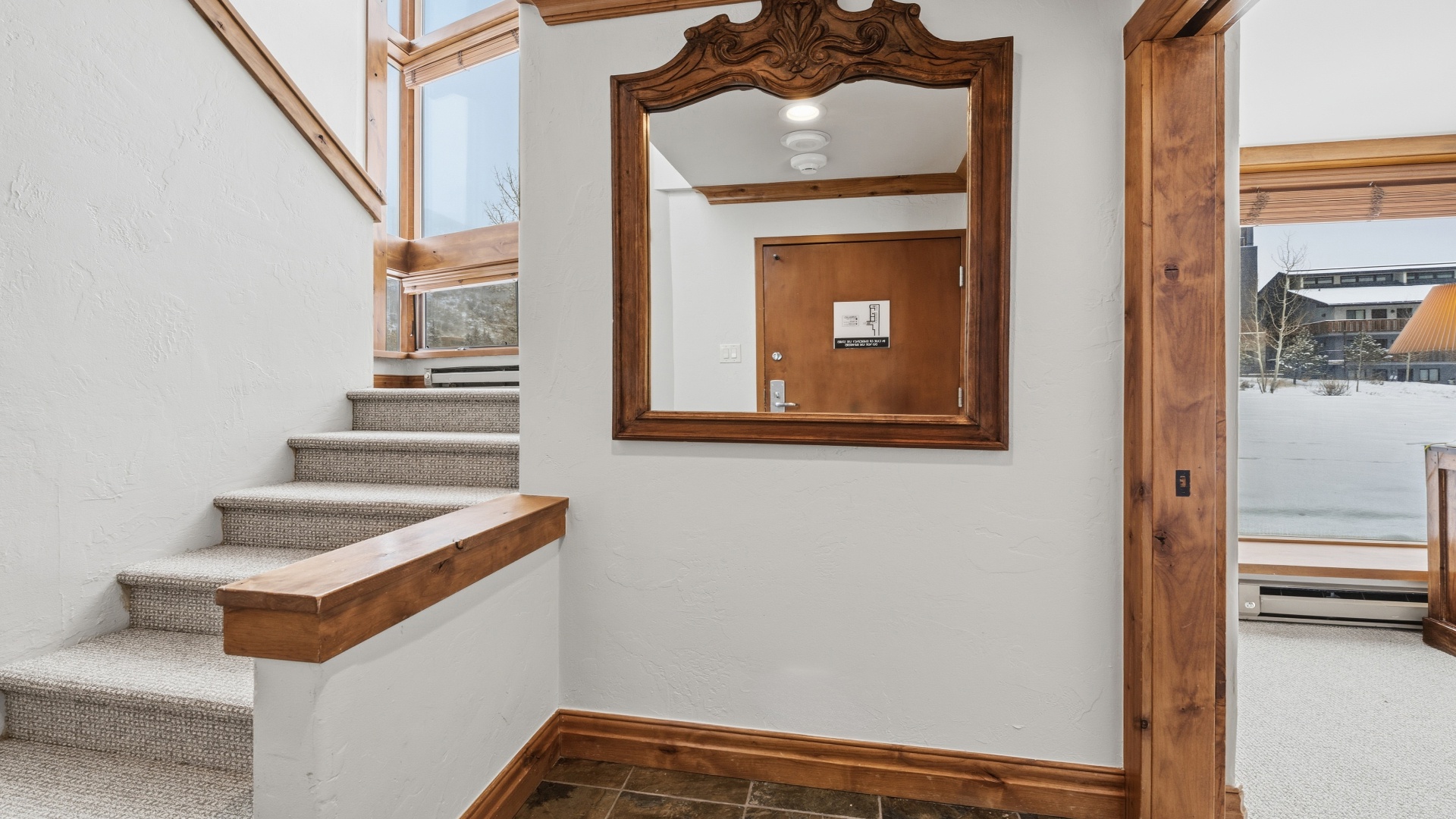 Step into a warm alpine retreat where natural light floods through custom wood-trimmed windows, creating the perfect welcome home after a day on the slopes.