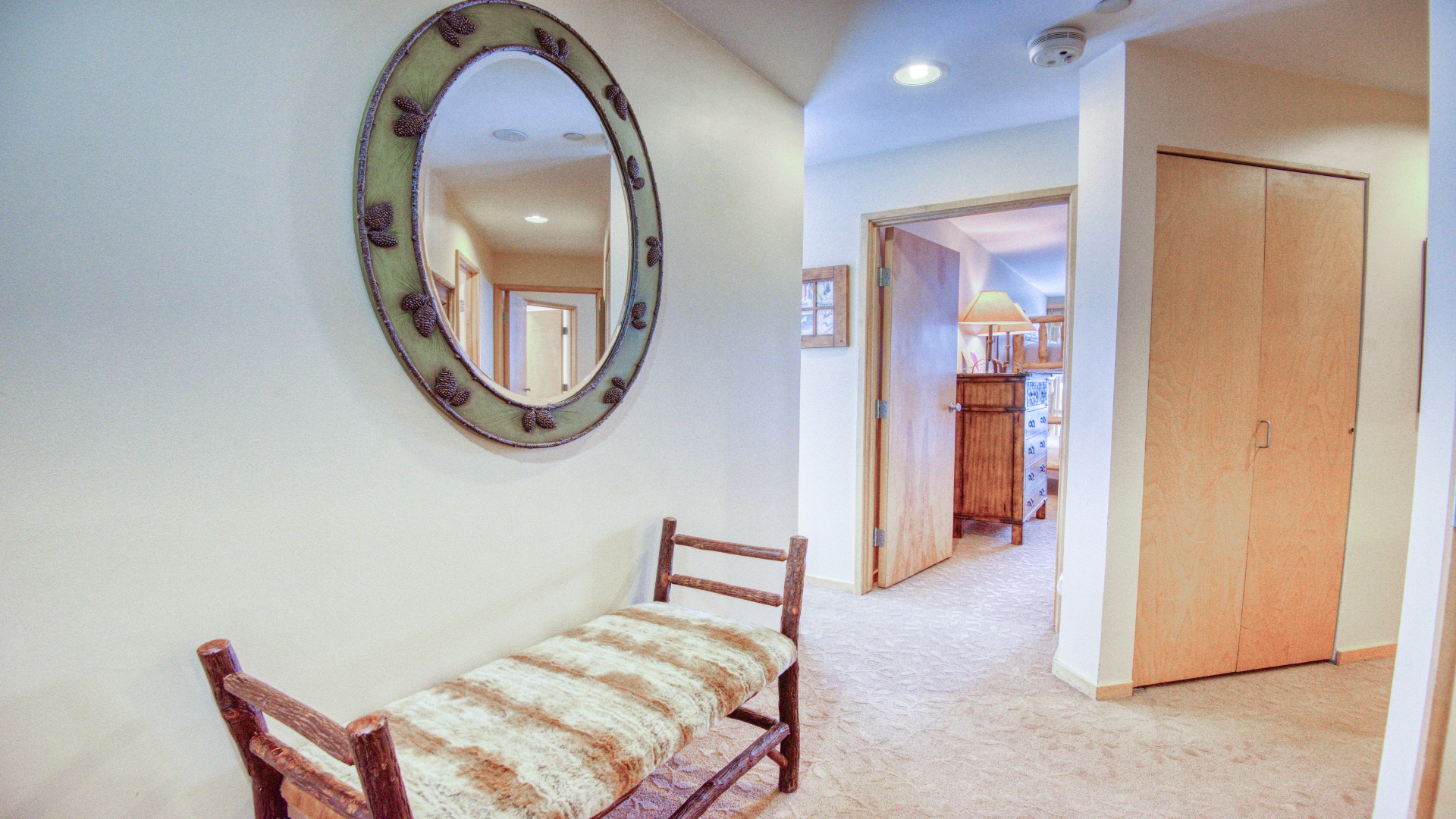 Bright, welcoming hallway with rustic charm connects your living spaces, featuring cozy bench seating and ample closet storage for your belongings.