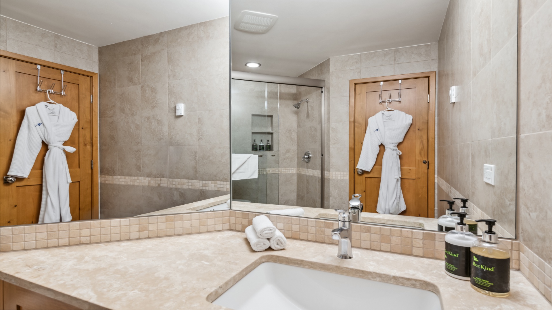 Refresh and unwind in your spacious bathroom with a walk-in shower, plush robes, and premium amenities ready for your arrival.