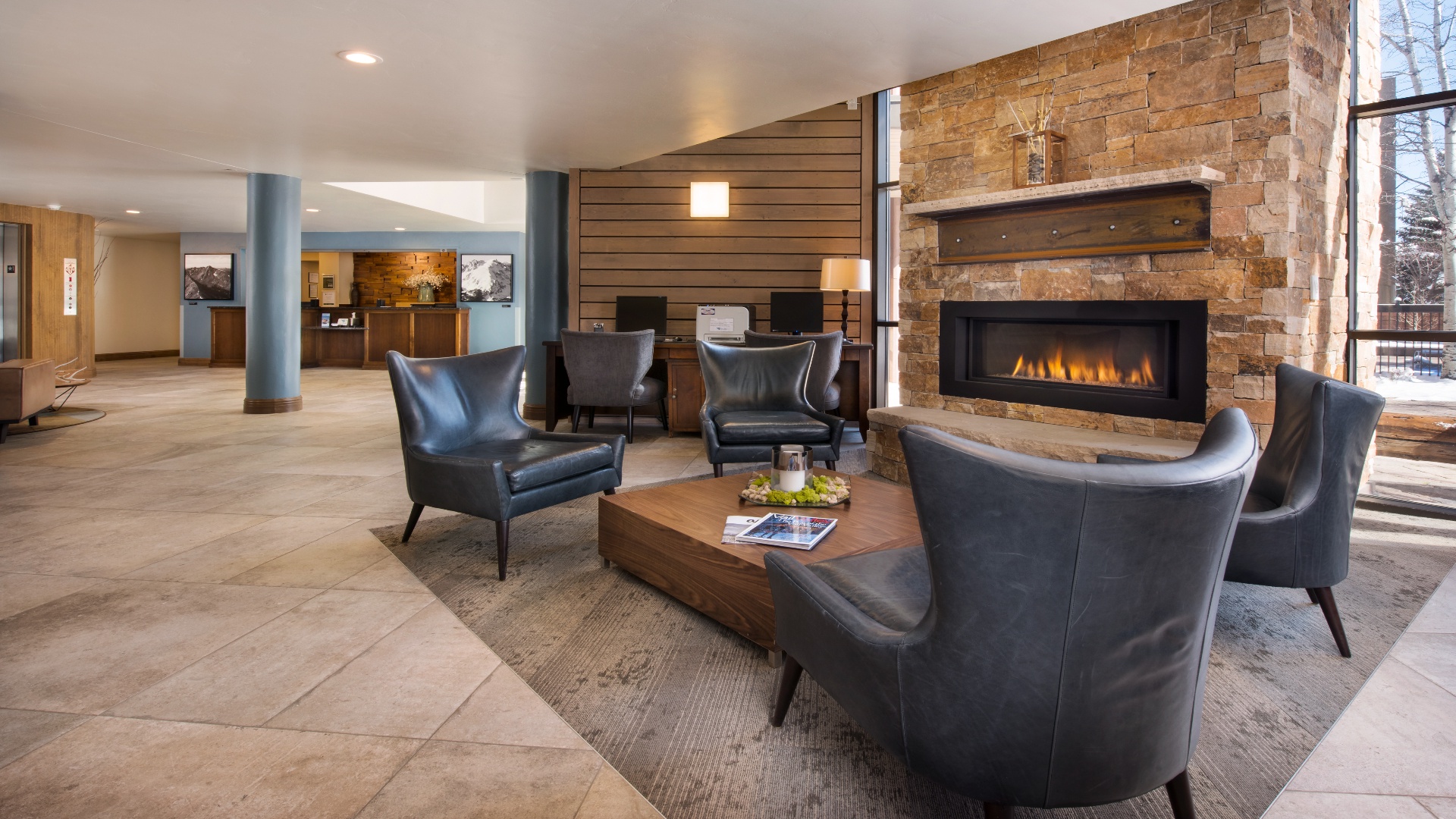 The lobby welcomes you with a striking stone fireplace, cozy leather seating, and warm wood accents—a perfect place to unwind after a day of adventure.