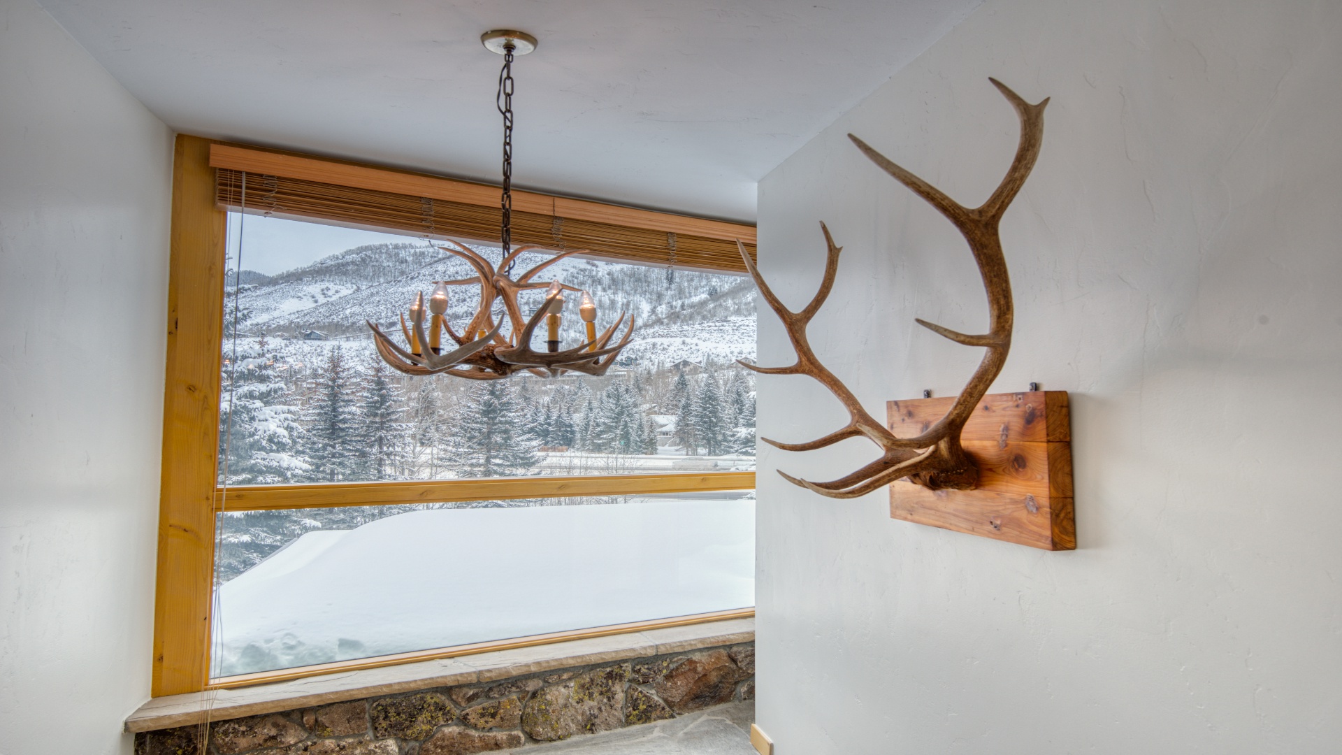 Stunning winter mountain scenery frames this cozy corner, where rustic lodge charm meets breathtaking alpine views—your perfect retreat for a peaceful snowy escape.