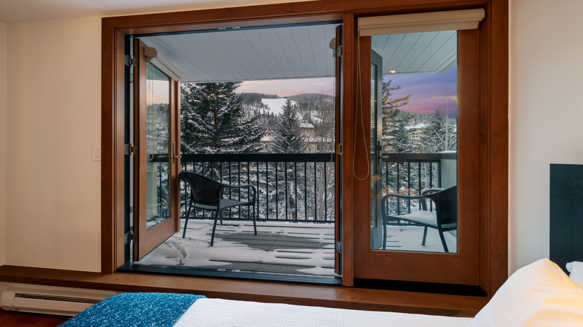 Step onto your private balcony and breathe in the crisp mountain air. Snow-dusted pines and soft twilight hues frame your alpine escape, where quiet mornings and serene evenings await.