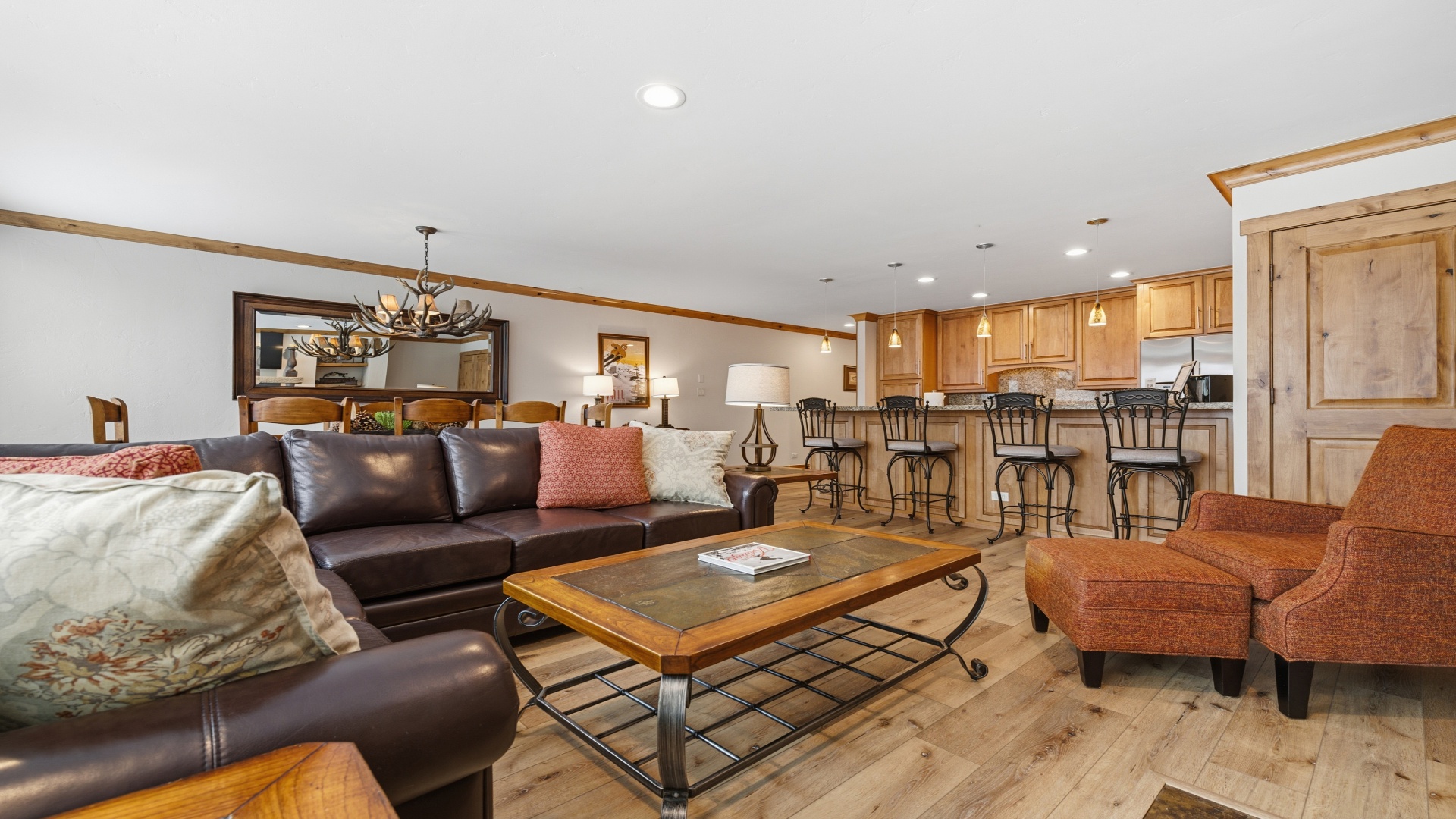 Sink into the leather sofas and feel instantly at home in this open-concept space. Gather around the warm wood dining table, chat at the breakfast bar, or simply unwind with your favorite show.