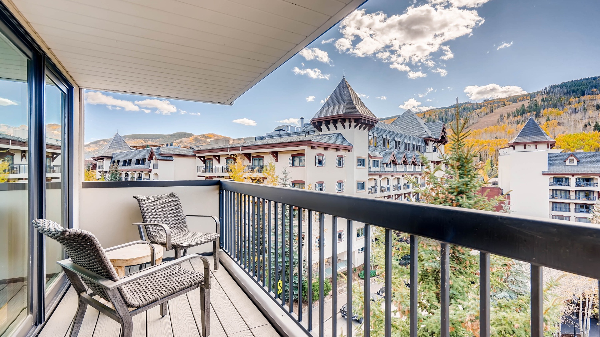 Step onto your private balcony and soak in the stunning mountain and village views. Relax in the seating area as you breathe in the crisp alpine air.