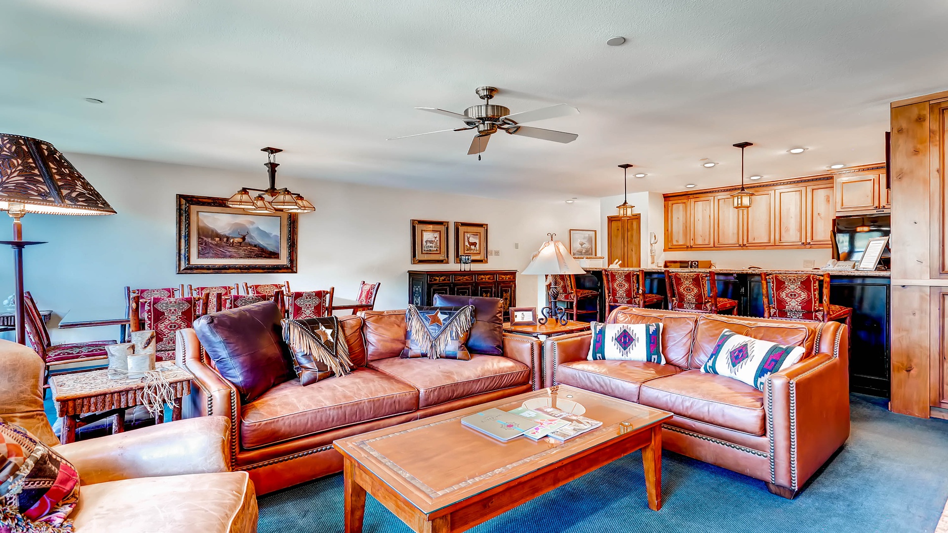 Sink into rich leather sofas and enjoy your mountain getaway in this open-concept living space. Warm wood accents and southwestern details create a welcoming atmosphere for memorable evenings with loved ones.