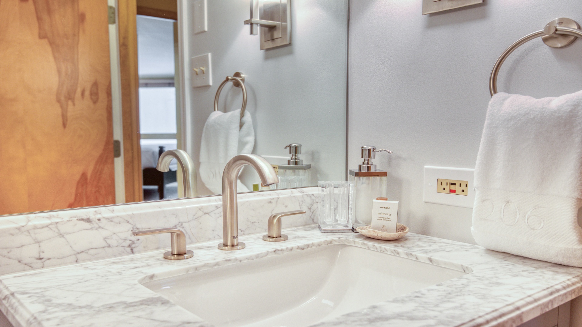 Refresh in your spa-like ensuite featuring a stunning marble vanity, elegant rose gold fixtures, and plush towels ready for your arrival.