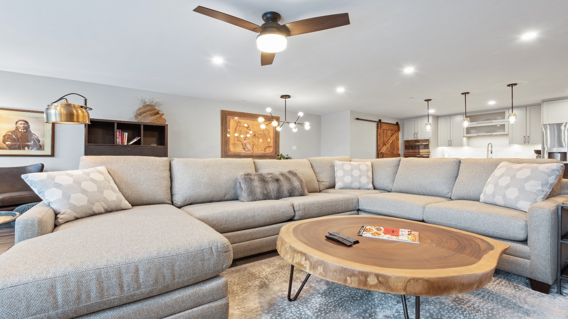 Sink into plush sectional seating where you can unwind with your favorite book or gather for movie nights. The open layout flows seamlessly into the kitchen, perfect for entertaining and making memories together.
