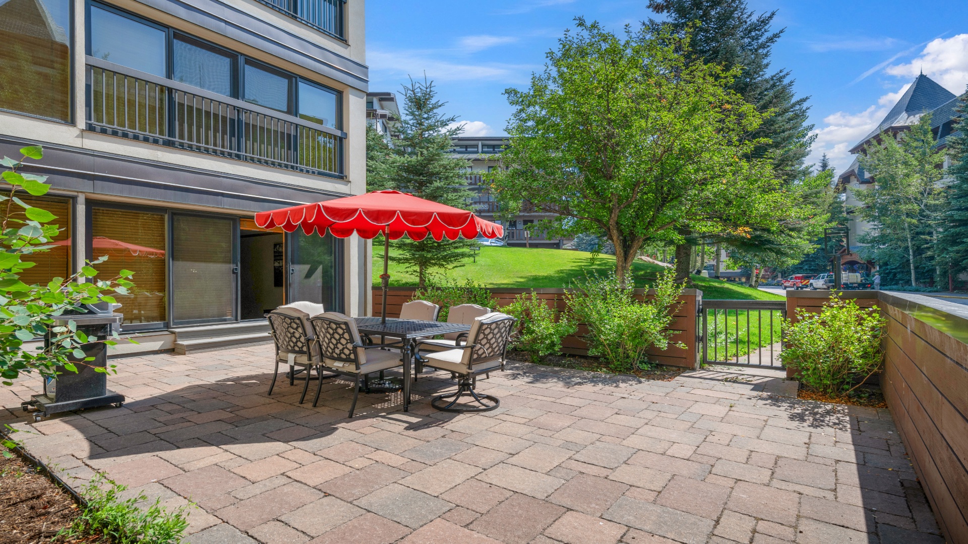 Your private patio invites you to unwind under the shade, surrounded by lush greenery and tranquil neighborhood views—perfect for morning coffee or evening meals outdoors.