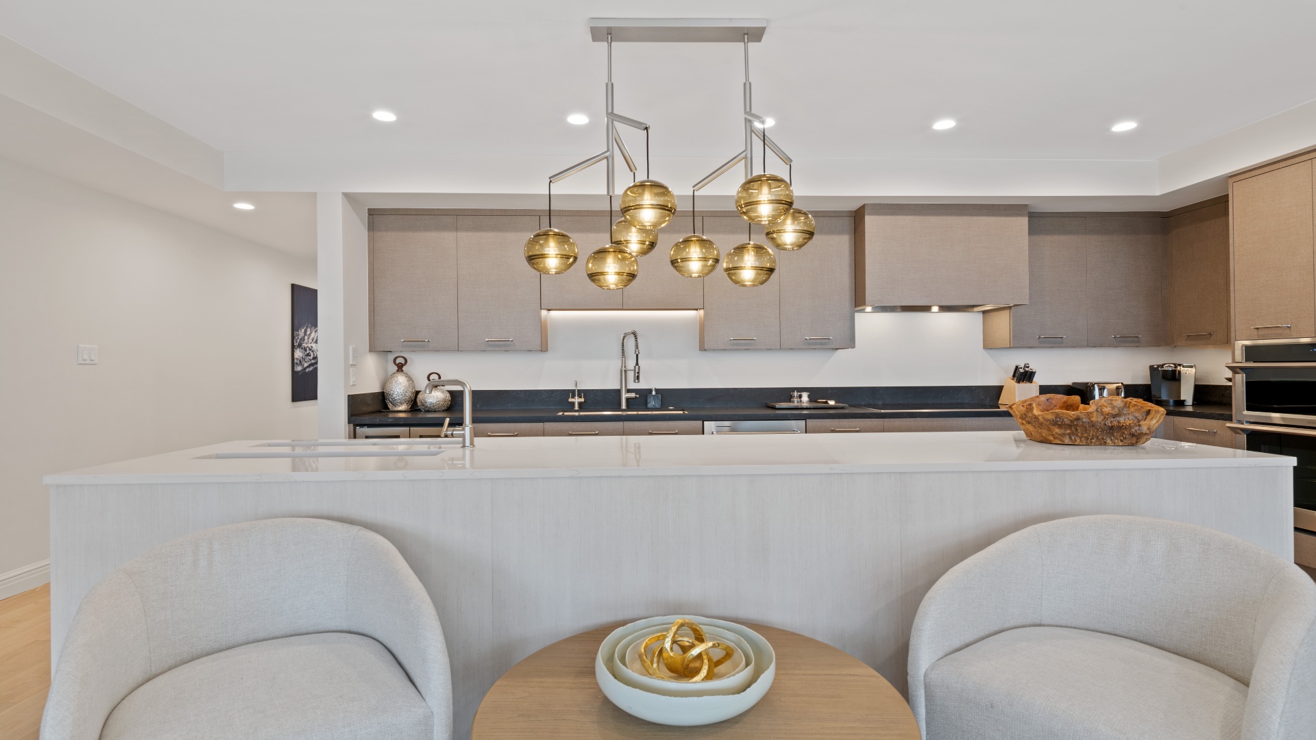 Gather around your spacious kitchen island with sleek countertops, modern pendant lighting, and everything you need to whip up memorable meals during your stay.