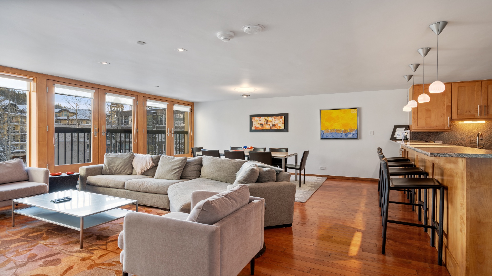 Unwind in your spacious open-plan living area with plush seating, warm hardwood floors, and a fully-equipped kitchen—perfect for gathering after a day of adventure.