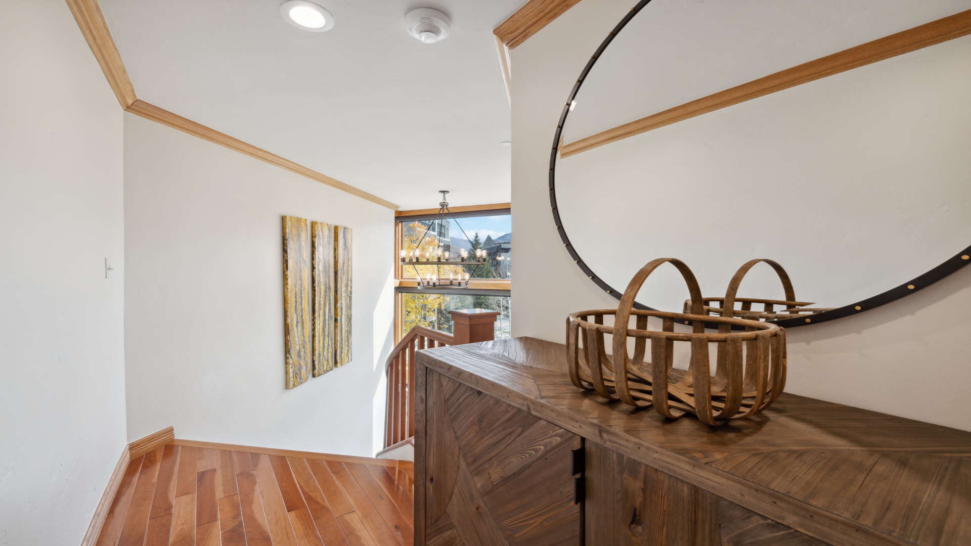 Step into a bright, modern space with warm wood accents and artistic touches. Natural light floods through the window, highlighting the unique design and inviting atmosphere.