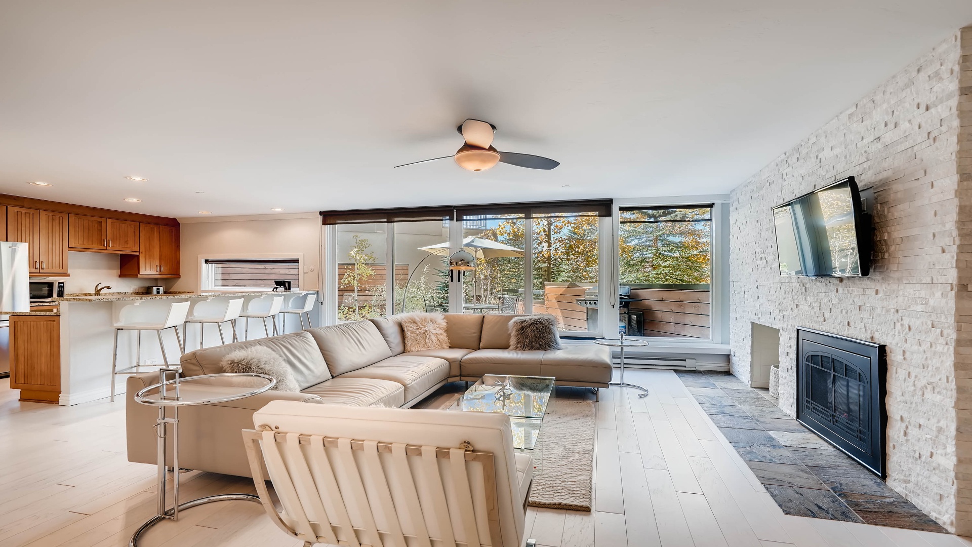 Your spacious open-concept retreat combines living, dining, and kitchen spaces with natural light flooding in through floor-to-ceiling windows. Relax by the fireplace or step onto your private deck.