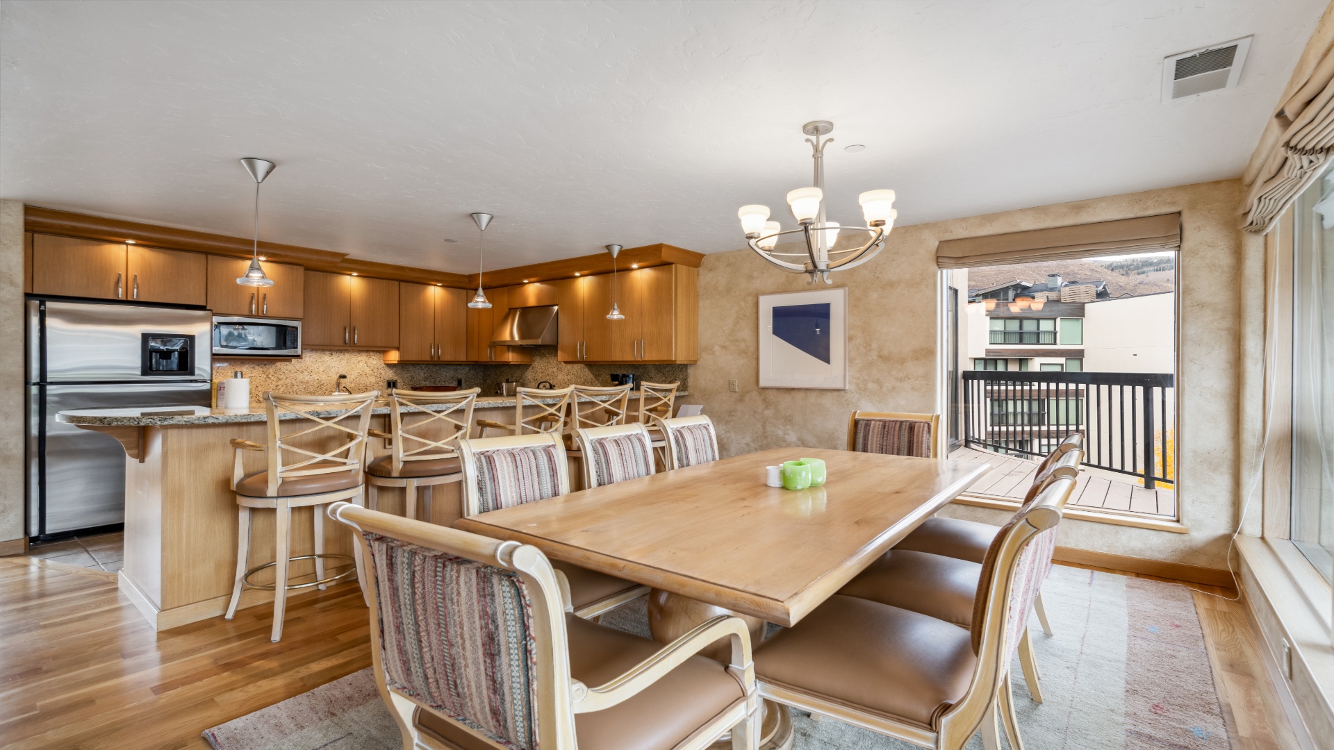 Your open-concept kitchen and dining area invites memorable meals together, with modern appliances, ample seating at the breakfast bar, and a spacious dining table perfect for hosting family gatherings.