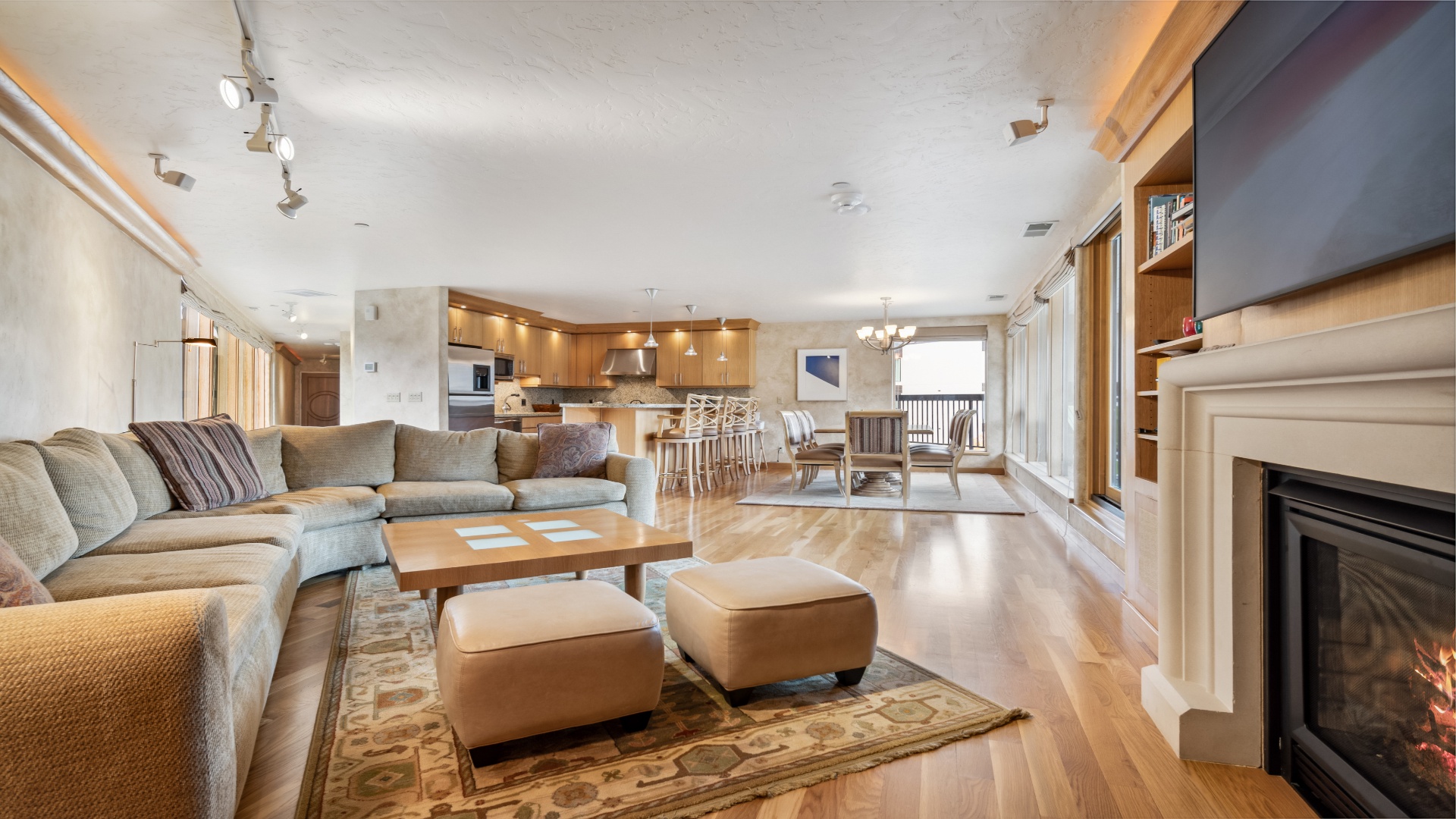 Picture yourself unwinding on the plush sectional by the warm fireplace, enjoying the spacious open layout that flows seamlessly from living to dining to your fully-equipped kitchen.