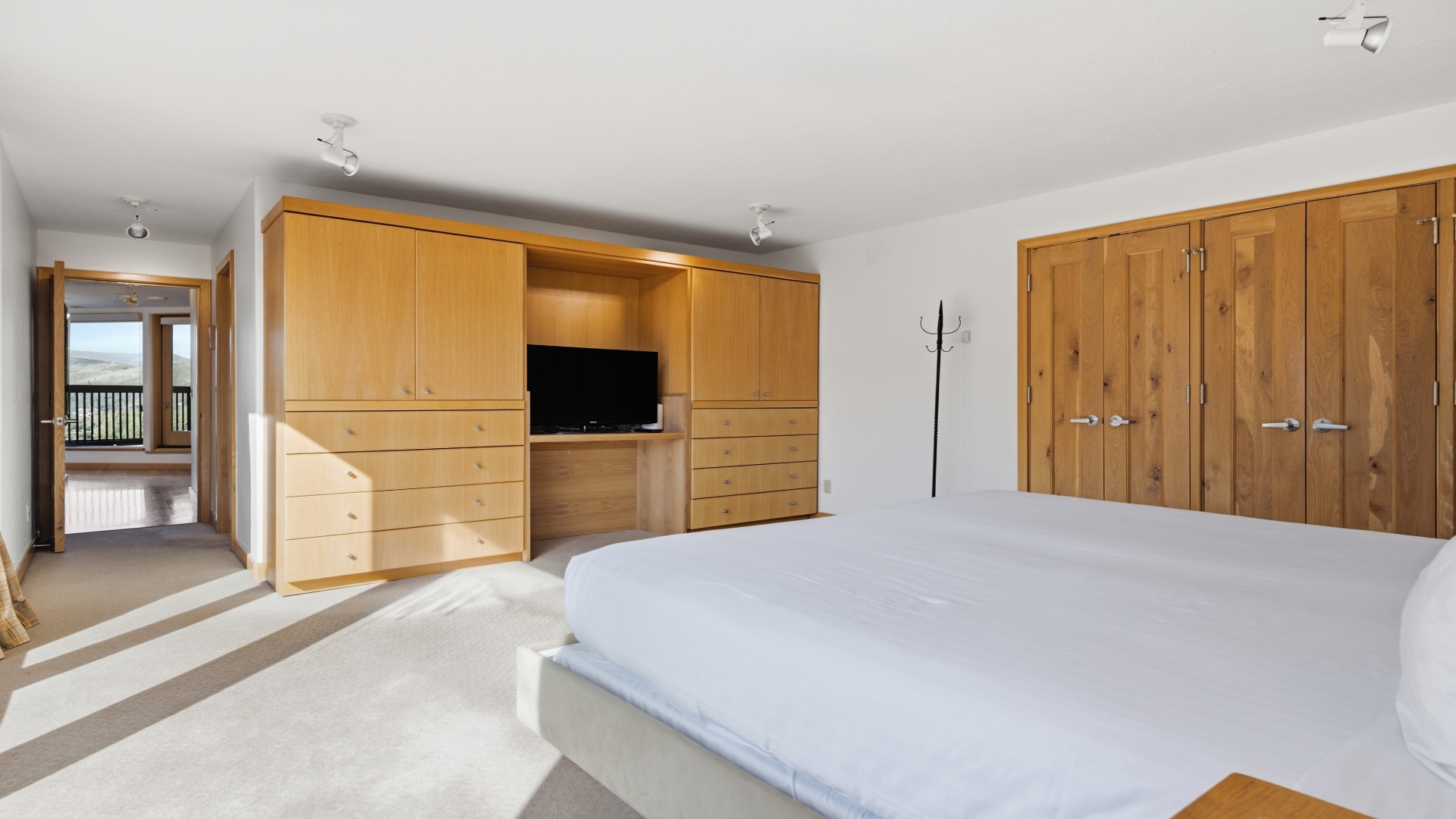 Settle into your spacious bedroom, where light wood furnishings and built-in storage create a serene, organized retreat. Warm natural tones and soft linens invite you to unwind after each day's adventures.