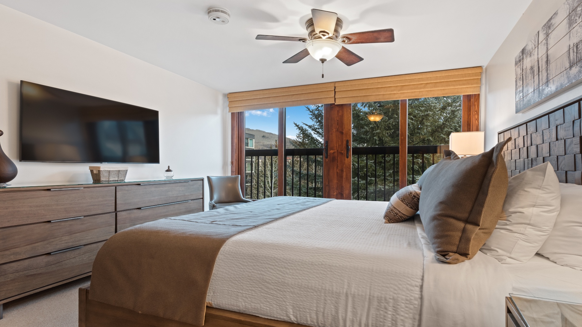 Your serene bedroom features a plush bed, modern amenities, and natural light streaming through the balcony doors—your peaceful retreat awaits.