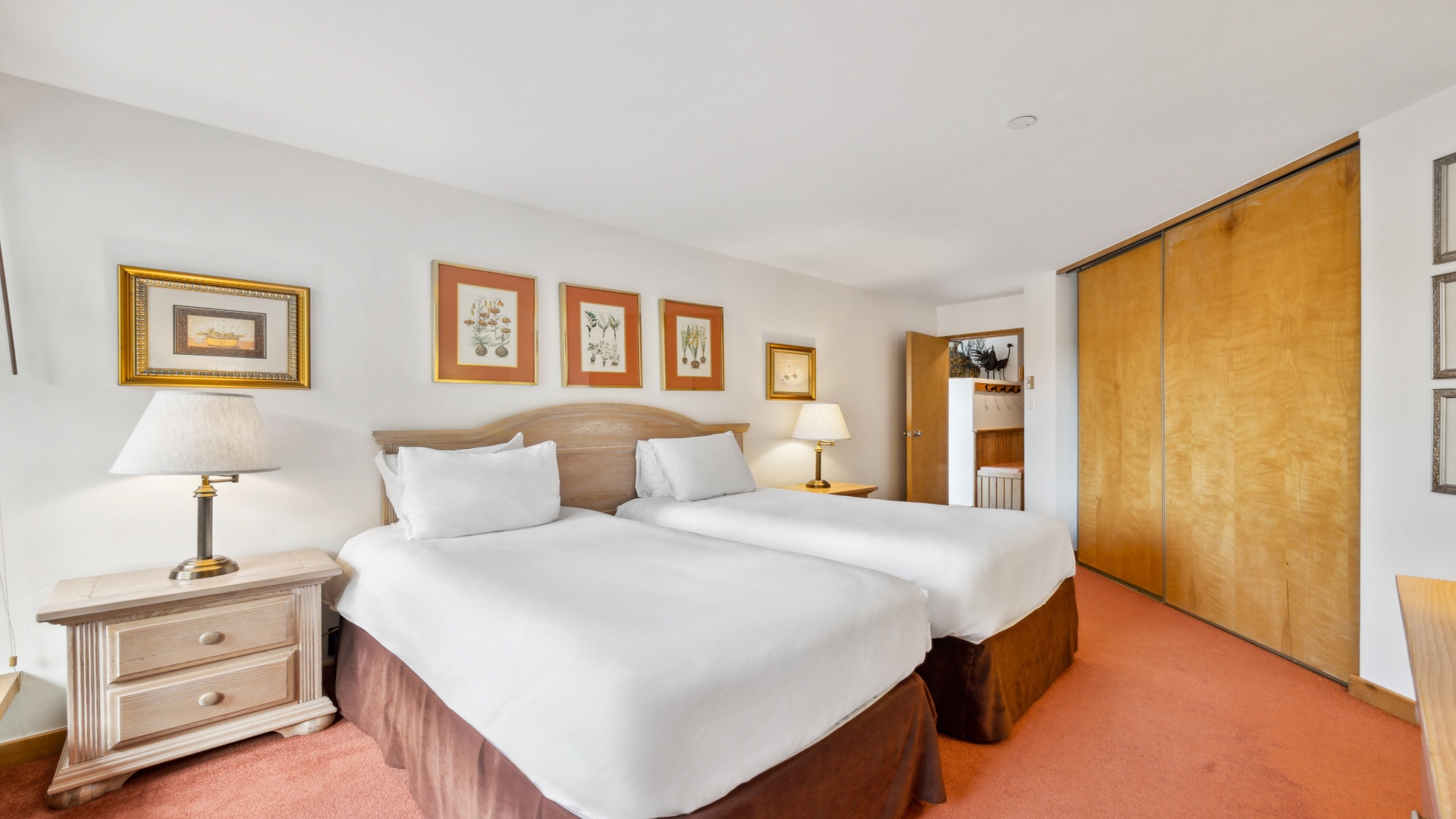 Sink into plush linens and wake refreshed in your bright bedroom, complete with two inviting beds, warm lighting, and ample closet space for your belongings.