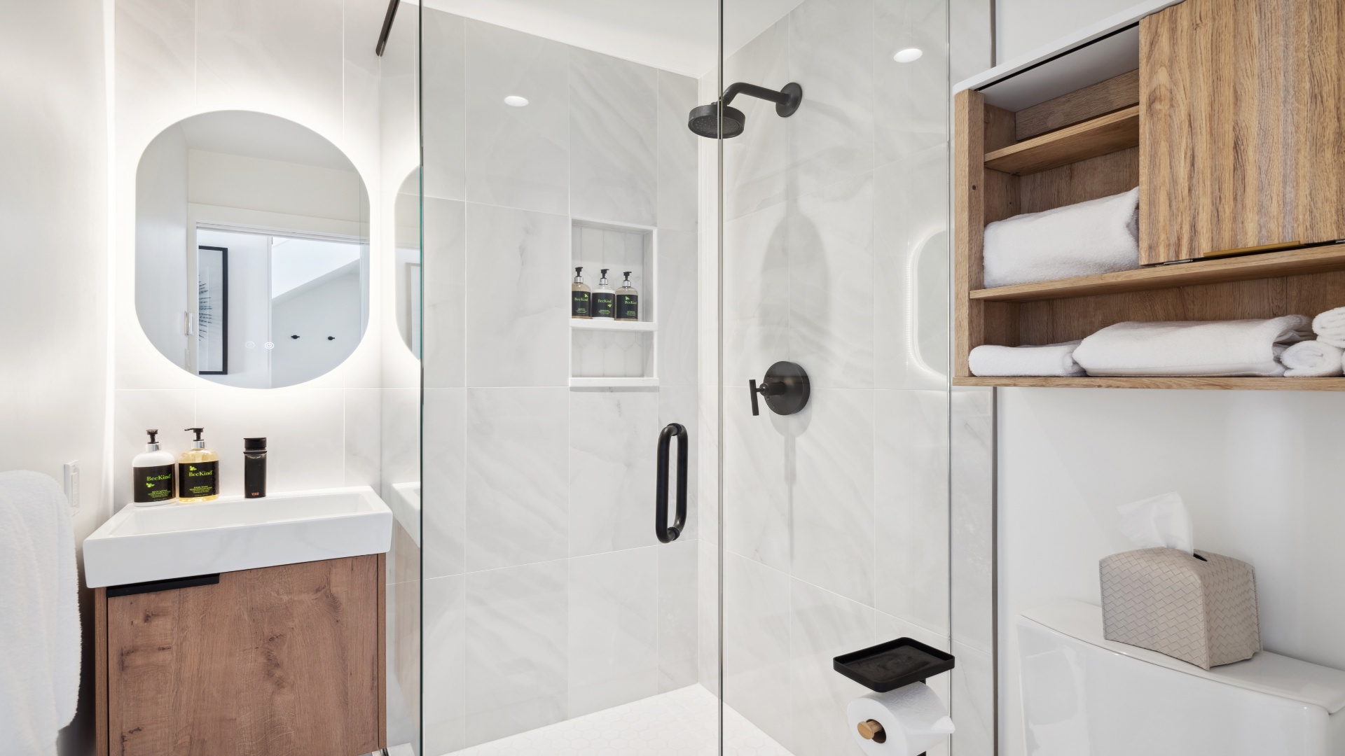 Step into your private spa-like retreat with a rainfall shower, backlit mirror, and neatly arranged fresh towels—everything you need to unwind after a day of adventure.