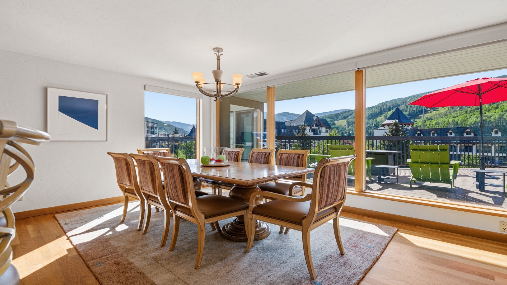 Gather with family and friends around the elegant dining table, where natural light and breathtaking mountain views create the perfect backdrop for memorable meals together.