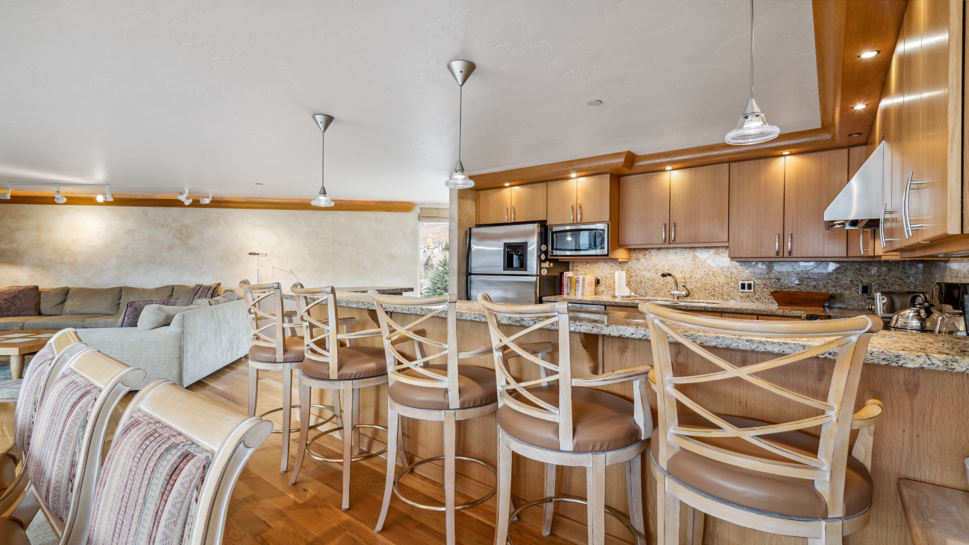 Gather around the spacious kitchen island for meals and conversation, with granite counters, stainless appliances, and a cozy living area just steps away for your group.
