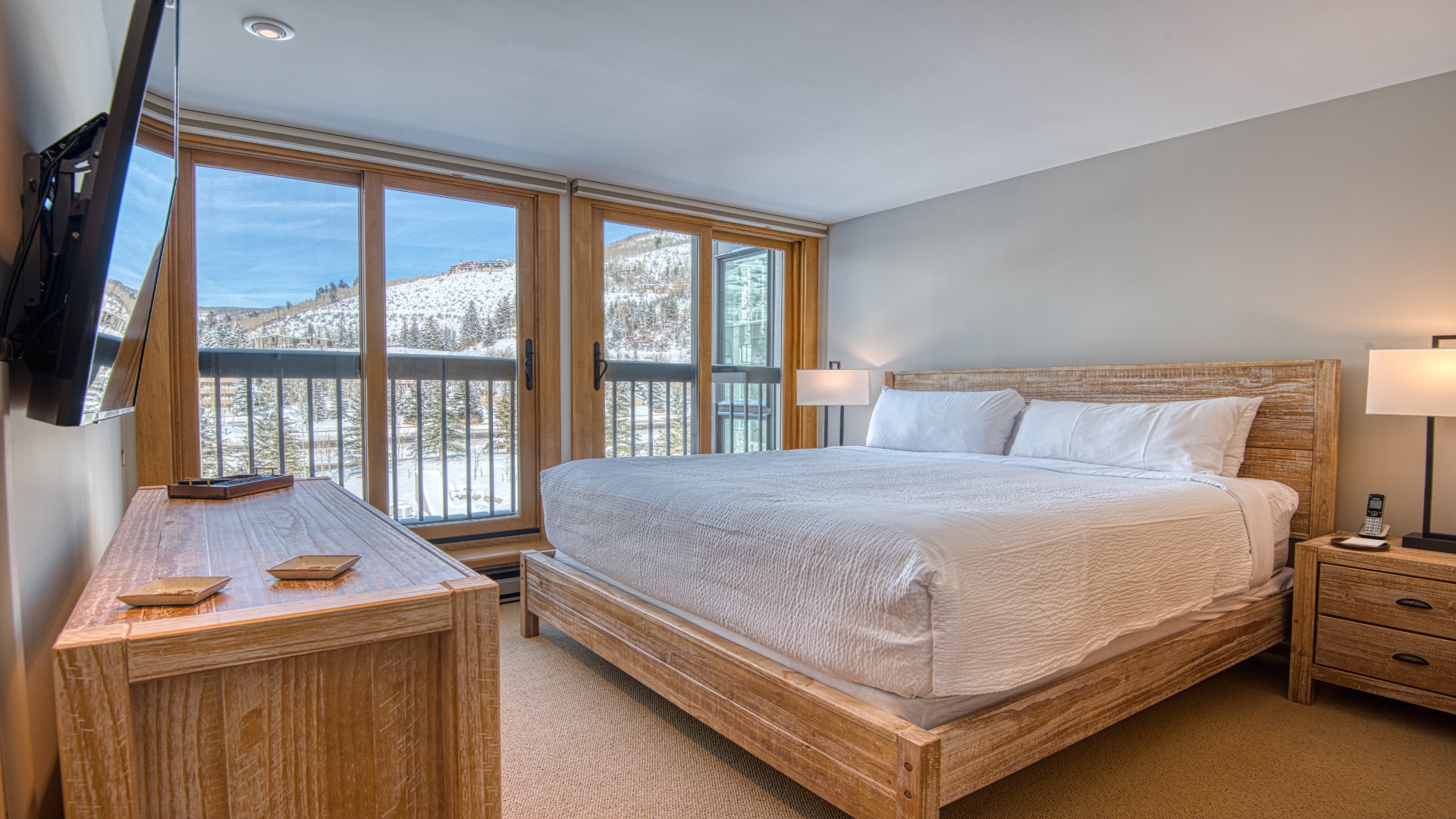Wake up to breathtaking snow-capped mountain views from your cozy bedroom. Step onto the balcony to breathe in crisp alpine air and soak in the peaceful winter landscape.