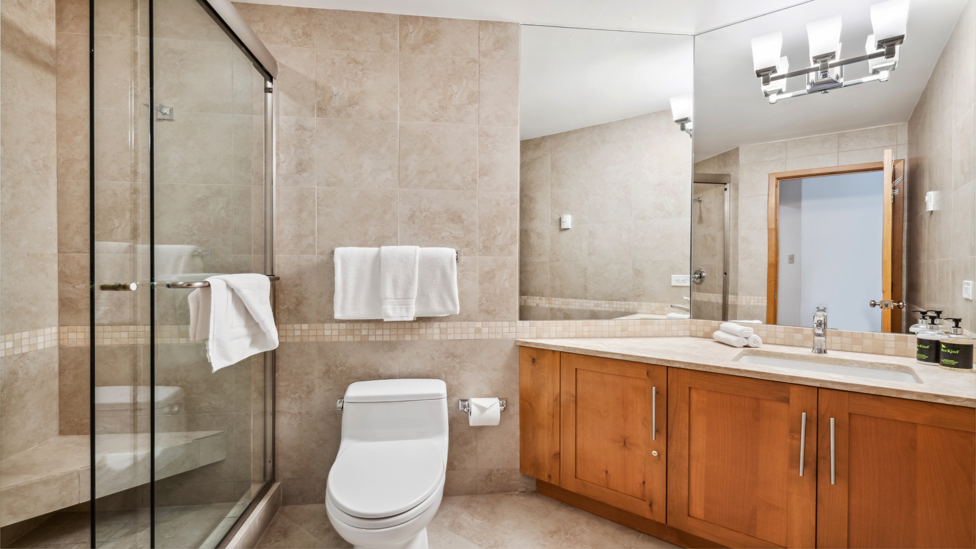 Relax in your private bathroom with a spacious walk-in shower, modern vanity, and plush towels waiting for you after a day of adventure.