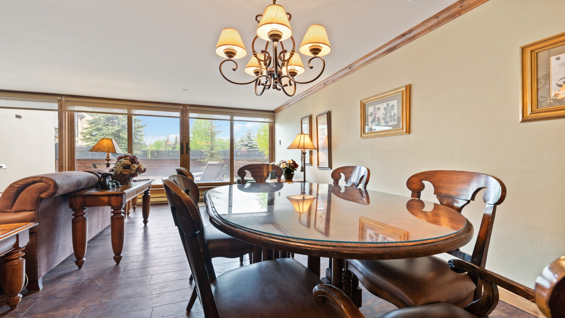 Gather around this elegant dining table where shared meals become cherished memories, bathed in natural light from expansive windows overlooking serene mountain views.