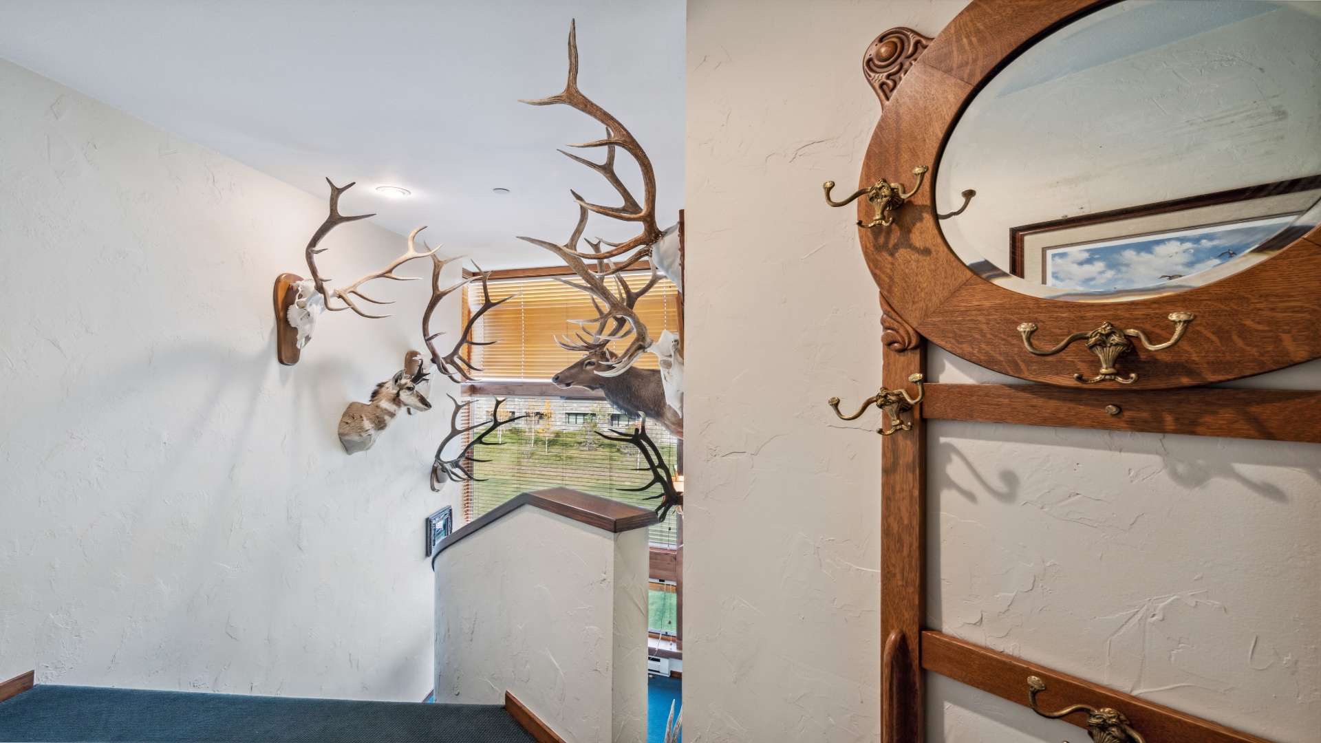 Rustic entryway featuring antler displays and warm wood accents that set a unique, outdoorsy tone as you arrive at this distinctive mountain-style retreat.