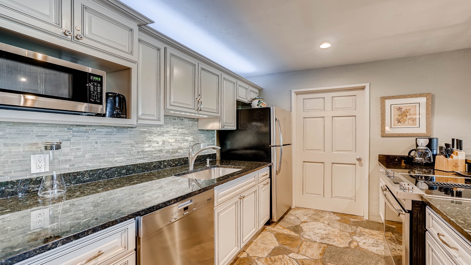 Your fully equipped kitchen features gleaming granite counters, stainless steel appliances, and plenty of cabinet space—everything you need to create your favorite meals in comfort.